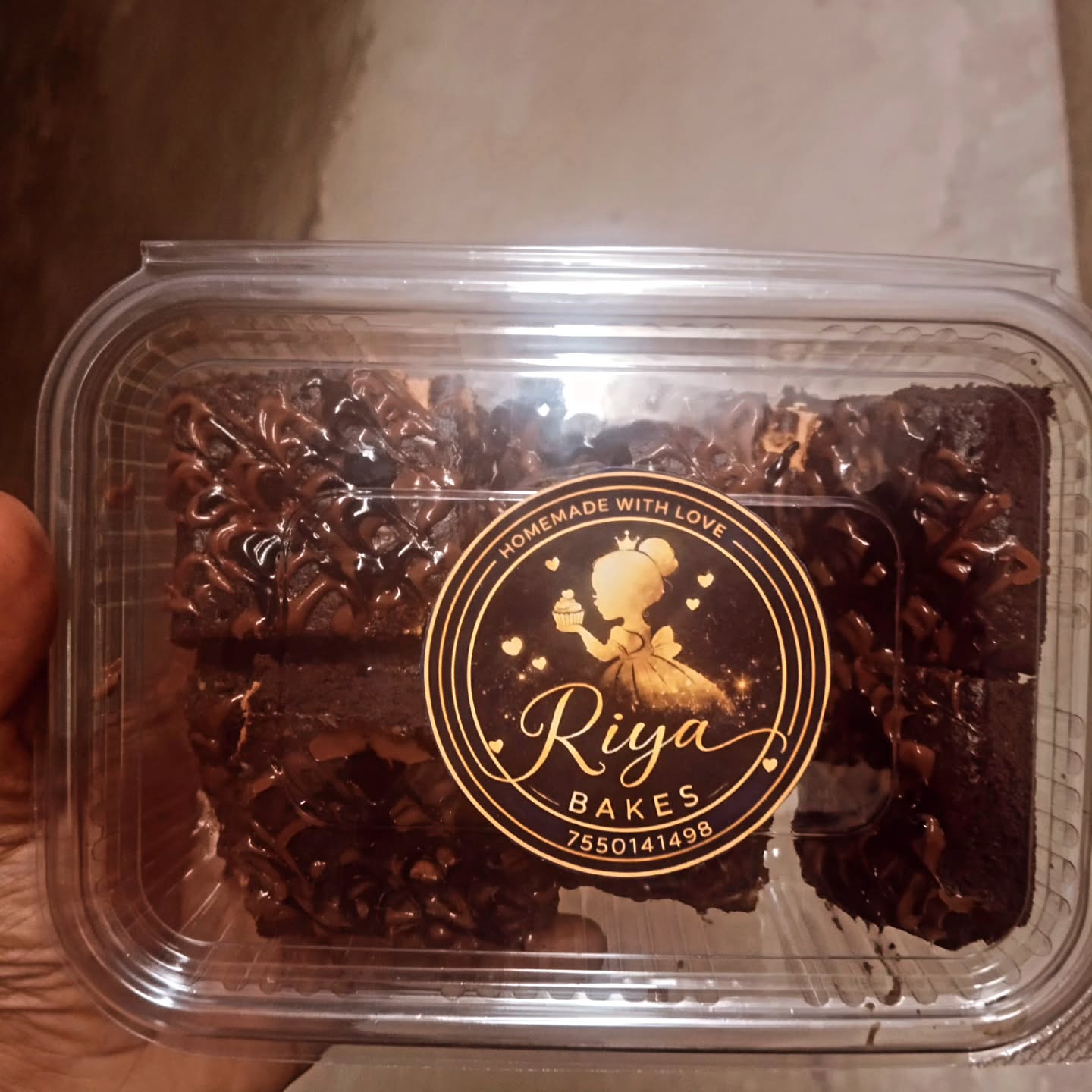 Brownie box sealed with the Riya Bakes sticker